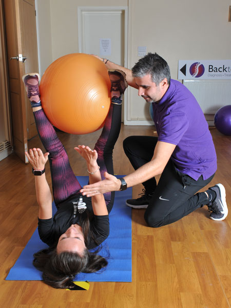Physiotherapy using swiss ball with client in Chester