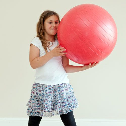 Young girl with swiss ball