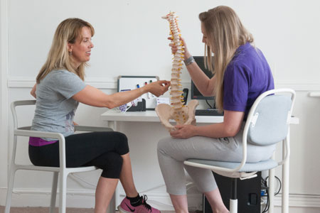 Patient talking to chiropractor in Wrexham