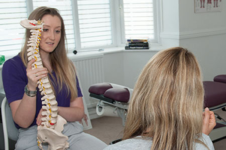 Chiropractor with patient in Wrexham